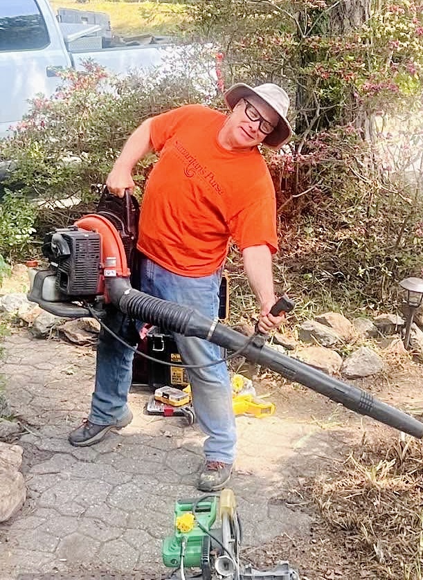 Men of Purpose volunteer using leaf blower