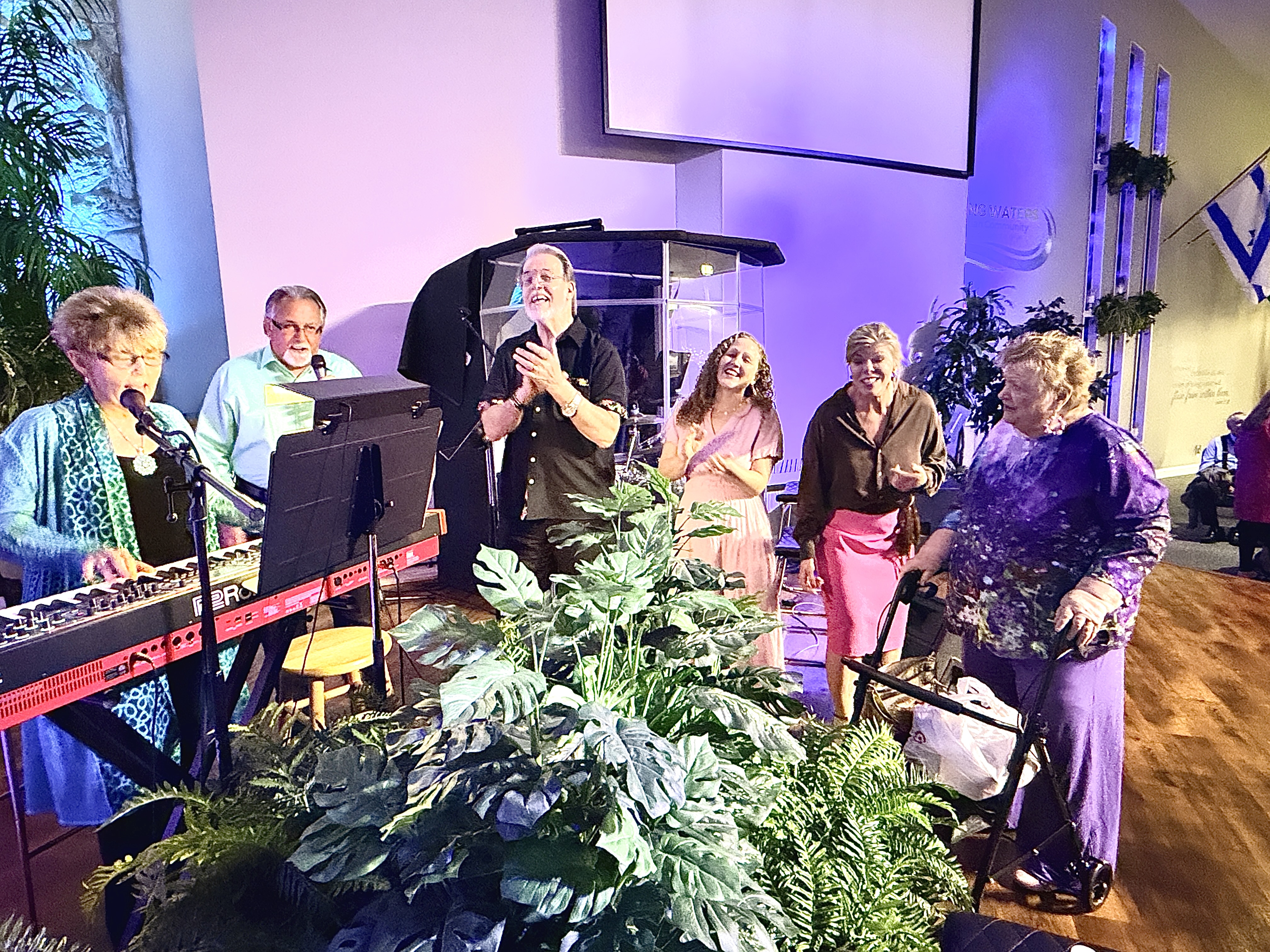 LWCC worship team gathered around the keyboard