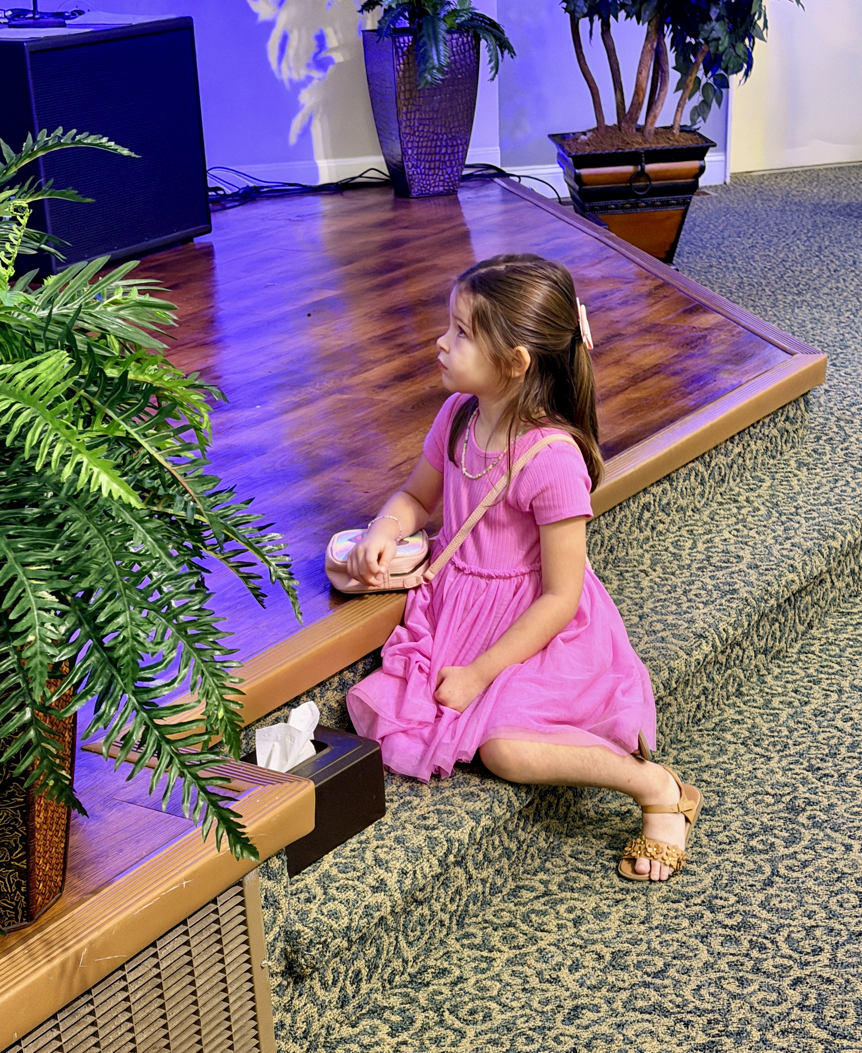 Young girl sitting at the edge of the platform