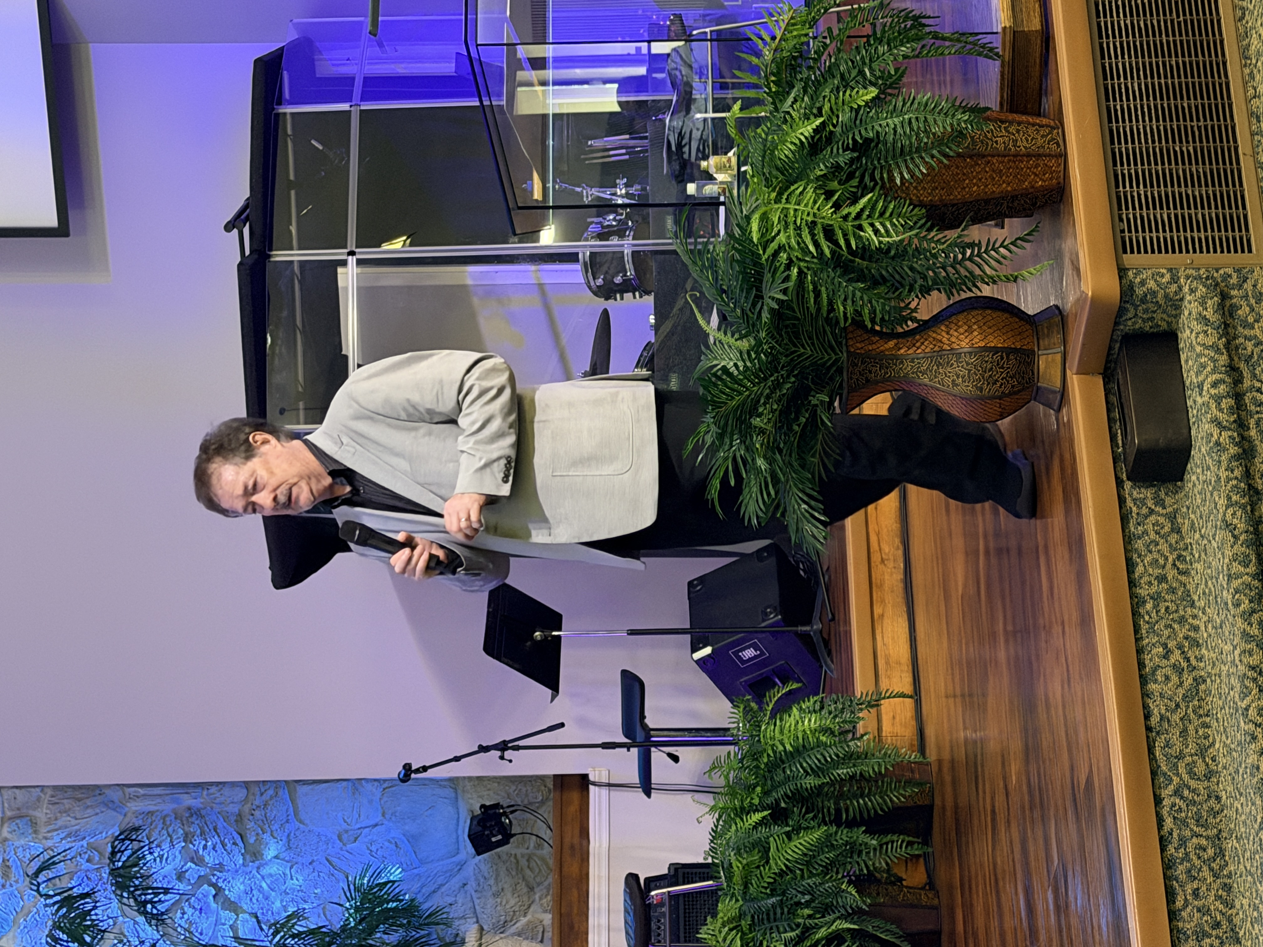 Pastor speaking from the platform at Living Waters